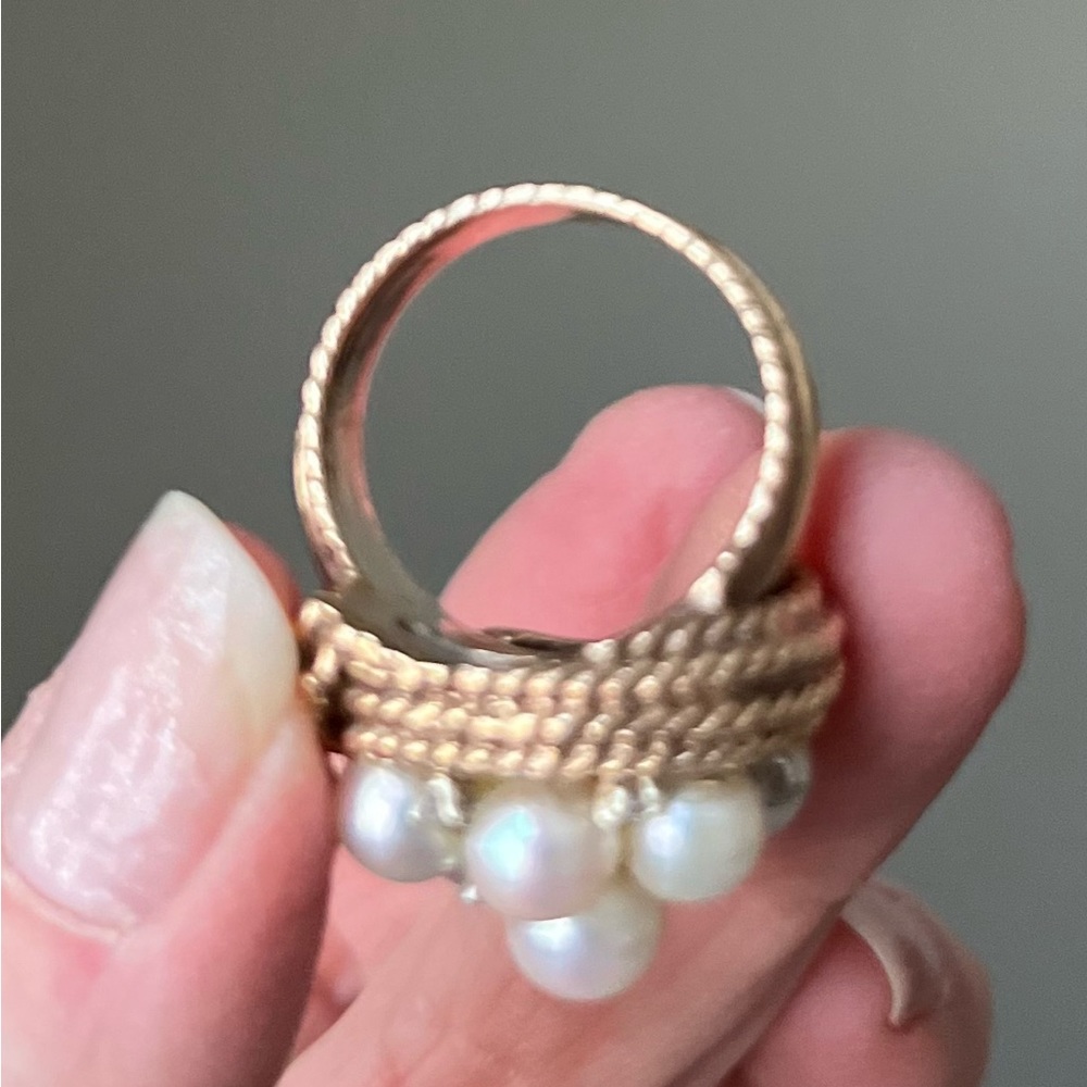 Pearl, diamond, and braided gold ring.